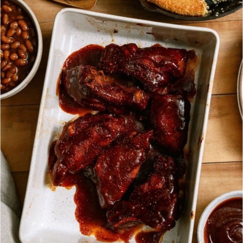 A baking dish full of Instant Pot BBQ Country Ribs in BBQ sauce.